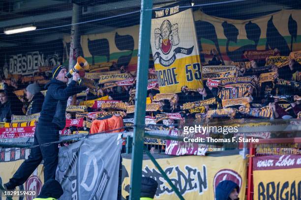 Supporters of Dresden cheer their team during the 3. Liga match between SC Verl and Dynamo Dresden at SPORTCLUB Arena on December 03, 2023 in Verl,...