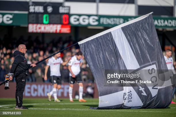Staff member Markus Schmand stands on the pitch during a minute of silence during the 3. Liga match between SC Verl and Dynamo Dresden at SPORTCLUB...