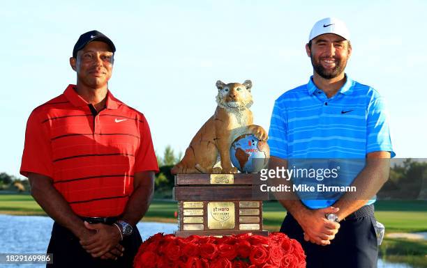 Scottie Scheffler of the United States and tournament host Tiger Woods pose with the trophy after winning the final round of the Hero World Challenge...