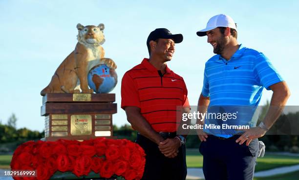 Scottie Scheffler of the United States and tournament host Tiger Woods pose with the trophy after winning the final round of the Hero World Challenge...