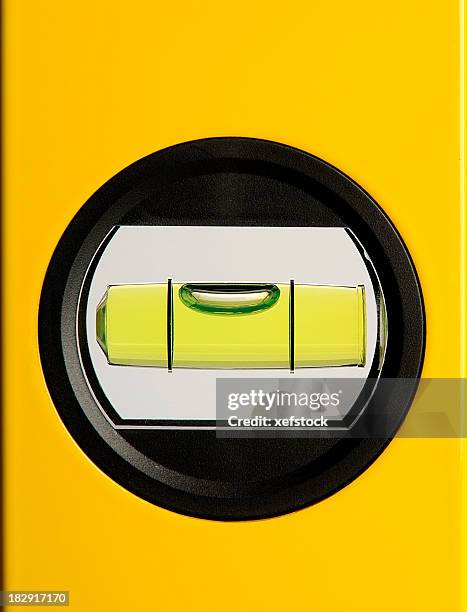 circular bubble level on a yellow background - waterpas stockfoto's en -beelden