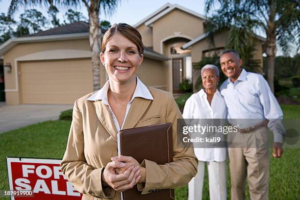 realtor con pareja afroamericana fuera de casa para venta - real estate sign fotografías e imágenes de stock