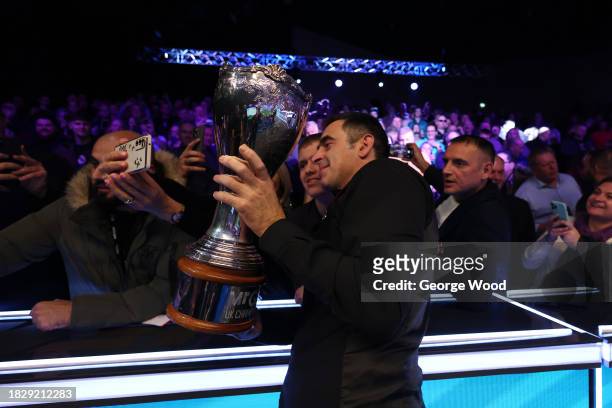 Ronnie O'Sullivan of England takes a selfie with fans following victory against Ding Junhui of China in their Final match on Day Nine of the MrQ UK...