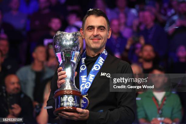 Ronnie O'Sullivan of England poses for a photo with the MrQ UK Snooker Championship 2023 trophy following victory against Ding Junhui of China in...