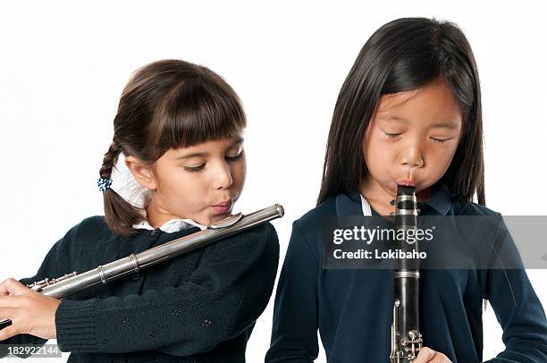 two little girls with woodwind instruments - clarinet stock pictures, royalty-free photos & images
