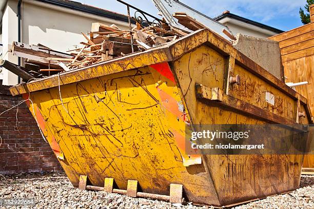 overflowing industrial bin filled with wooden scraps - rubble stockfoto's en -beelden