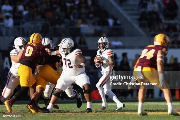 Quarterback Noah Fifita of the Arizona Wildcats drops back to pass during the second half of the NCAAF game against the Arizona State Sun Devils at...