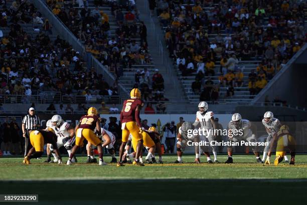 Quarterback Noah Fifita of the Arizona Wildcats prepares to snap the football during the second half of the NCAAF game against the Arizona State Sun...