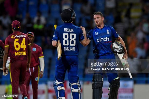 Jos Buttler and Harry Brook of England celebrate winning the 2nd ODI match between the West Indies and England at Vivian Richards Cricket Stadium in...