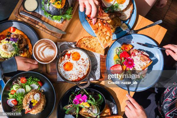 enjoying a brunch together. - matbord bildbanksfoton och bilder