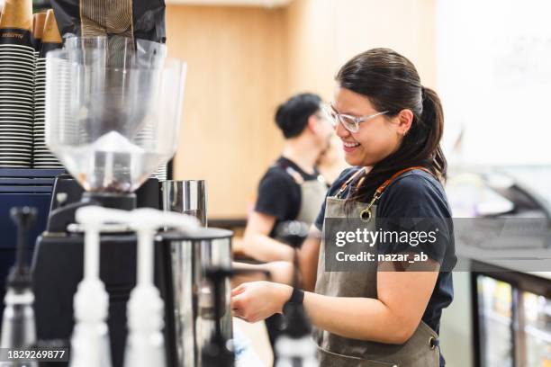 barista making coffee for customers at cafe. - barista stock pictures, royalty-free photos & images