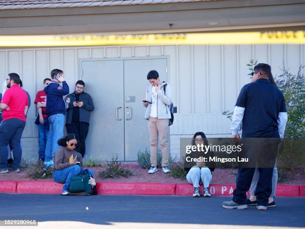 People wait on the outskirts of the UNLV campus after a shooting on December 06, 2023 in Las Vegas, Nevada. According to Las Vegas Metro Police, a...