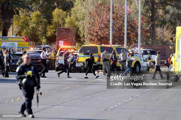 Police evacuate students on Harmon Avenue near Maryland Parkway after a shooting on the UNLV campus in Las Vegas Wednesday, Dec. 6, 2023.
