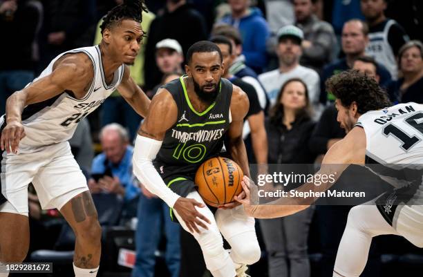 Mike Conley of the Minnesota Timberwolves drives with the ball in the first quarter of the game against the San Antonio Spurs at Target Center on...