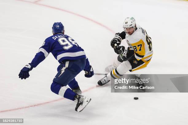 Sidney Crosby of the Pittsburgh Penguins against Mikhail Sergachev of the Tampa Bay Lightning during the first period at Amalie Arena on December 6,...