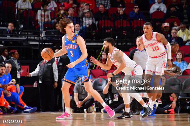 Josh Giddey of the Oklahoma City Thunder handles the ball during the game agains the Houston Rockets on December 6, 2023 at the Toyota Center in...