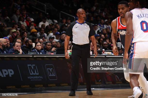 Referee Michael Smith looks on during the Philadelphia 76ers game against the Washington Wizards on December 6, 2023 at Capital One Arena in...