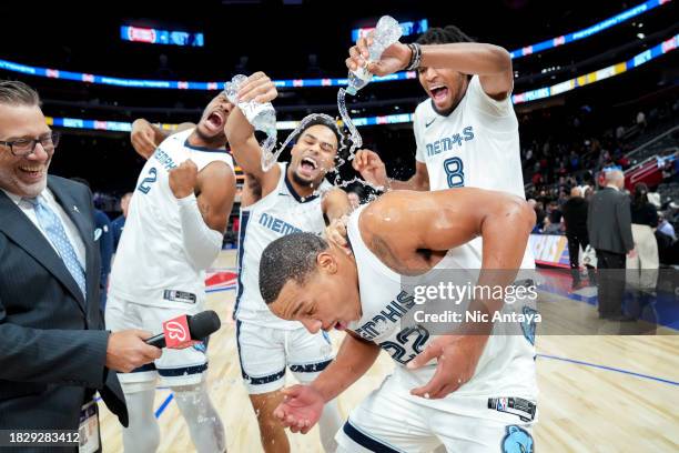 Xavier Tillman of the Memphis Grizzlies, Jacob Gilyard of the Memphis Grizzlies and Ziaire Williams surprise Desmond Bane of the Memphis Grizzlies...