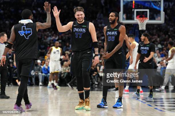Luka Doncic and Derrick Jones Jr. #55 of the Dallas Mavericks smile during the game against the Utah Jazz on December 6, 2023 at the American...