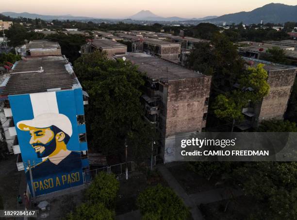 Aerial view of a mural depicting Salvadoran President Nayib Bukele in the Zacamil neighborhood of San Salvador, taken on December 2, 2023. Under a...