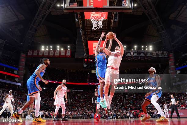 Alperen Sengun of the Houston Rockets and Jaylin Williams of the Oklahoma City Thunder battle for a rebound during the game on December 6, 2023 at...