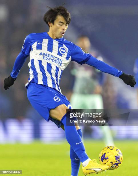 Brighton's Kaoru Mitoma passes the ball in a Premier League match against Brentford in Brighton, England, on Dec. 6, 2023.