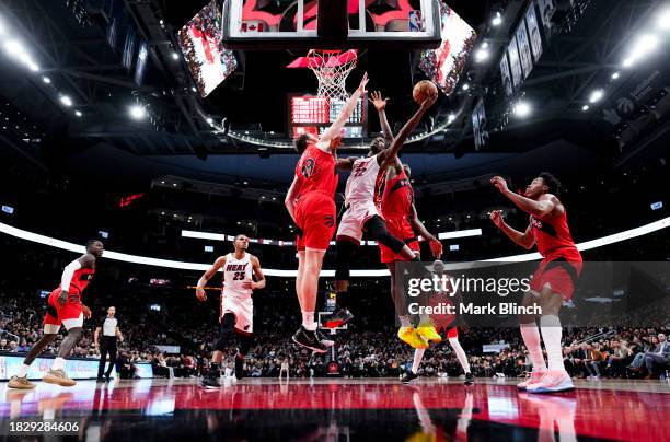 Jimmy Butler of the Miami Heat goes to the basket against Jakob Poeltl of the Toronto Raptors during the second half of their basketball game at the...