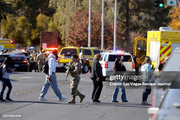 Police evacuate students on Harmon Avenue near Maryland Parkway after a shooting on the UNLV campus in Las Vegas Wednesday, Dec. 6, 2023.