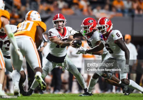Georgia Bulldogs quarterback Carson Beck hands off to Georgia Bulldogs running back Kendall Milton during a college football game between the...