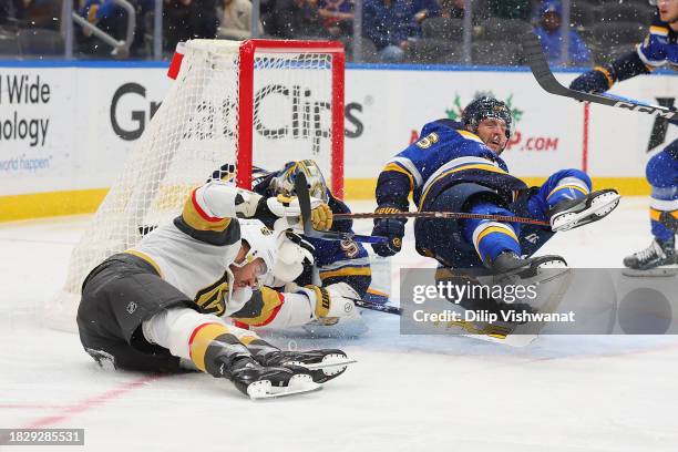 Marco Scandella of the St. Louis Blues collides with William Carrier of the Vegas Golden Knights during the second period at Enterprise Center on...