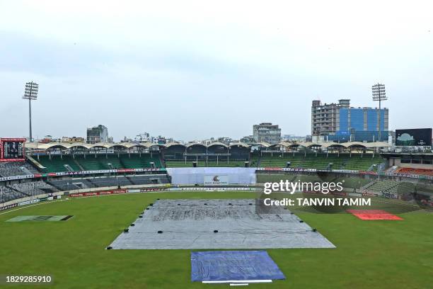 The covered pitch is pictured as rain delays the second day play of the second Test cricket match between Bangladesh and New Zealand at the...