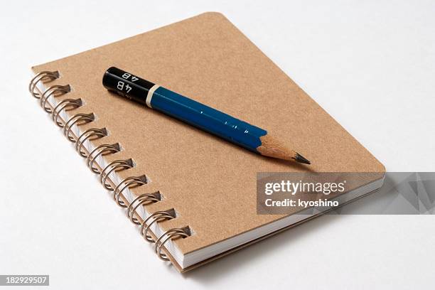 isolated shot of spiral notebook with pencil on white background - pen stockfoto's en -beelden