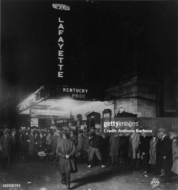 View of the crowds outside the Lafayette Theater, in Harlem, gathered for a performance by Johnny Hudgins and the Cotton Club Band, New York, 1920s.