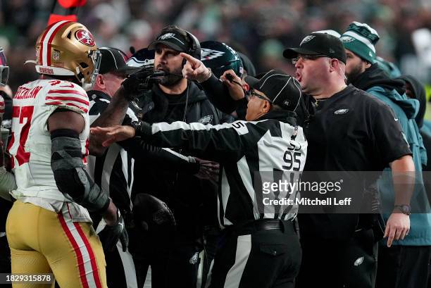 Dre Greenlaw of the San Francisco 49ers exchanges words with Philadelphia Eagles head coach Nick Sirianni and Dom DiSandro at Lincoln Financial Field...