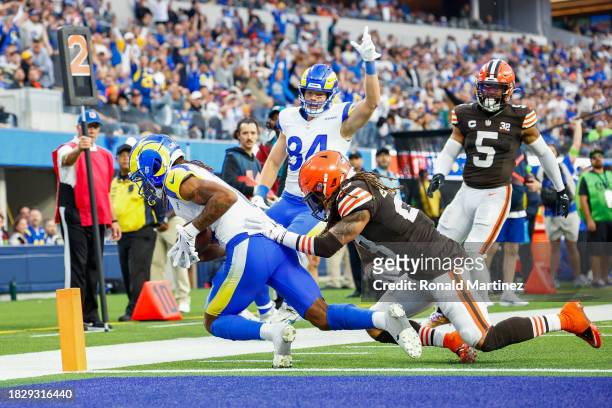 Demarcus Robinson of the Los Angeles Rams celebrates after scoring a touchdown past Mike Ford of the Cleveland Browns in the third quarter at SoFi...