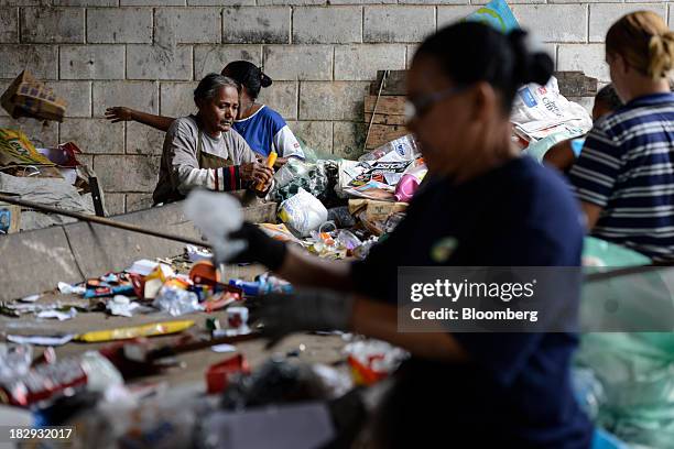 Workers separate trash for recycling at the COOPERVIVA garbage sorting facility in Rio Claro, Brazil , on Tuesday, Oct. 1, 2013. COOPERVIVA,...