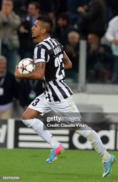 Arturo Vidal of Juventus celebrates after scoring his team's first goal from a penalty to equalise during the UEFA Champions League Group B match...