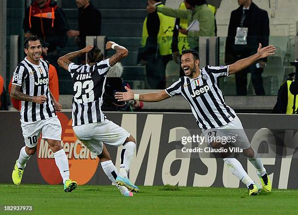 Fabio Quagliarella of Juventus celebrates with team-mates Arturo Vidal and Carlos Tevez after scoring their team's second goal during UEFA Champions...