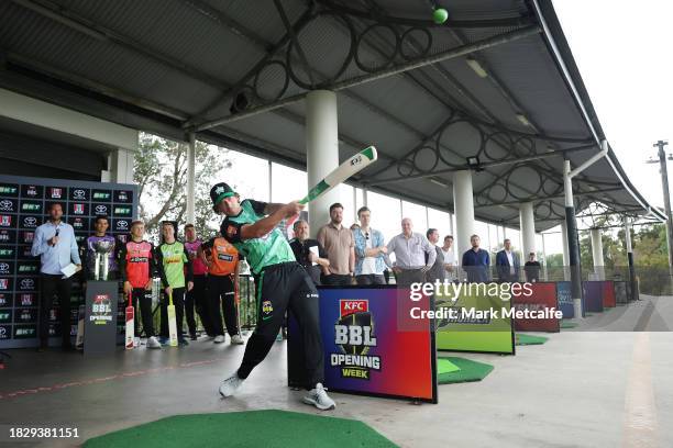 Joe Burns of the Melbourne Stars hits on the driving range during the 2023-24 Big Bash League season launch at the Moore Park Driving Range on...