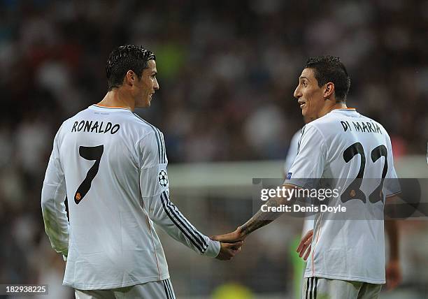 Angel Di Maria of Real Madrid CF celebrates with team-mate Cristiano Ronaldo after scoring their team's third goal during the UEFA Champions League...