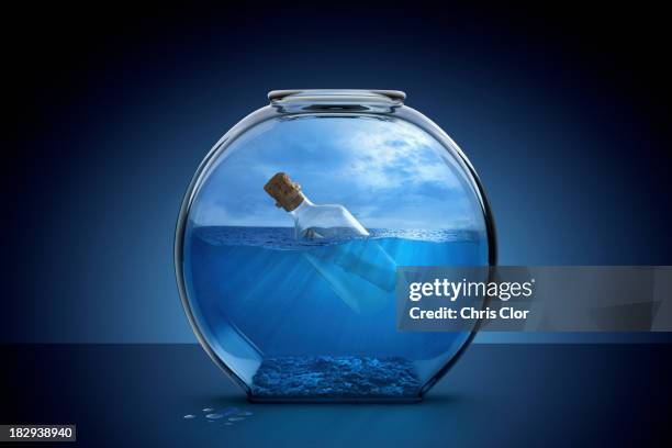 message in a bottle in fishbowl - message in a bottle floating in ocean stock pictures, royalty-free photos & images