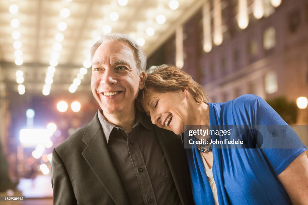 Caucasian couple walking on city street