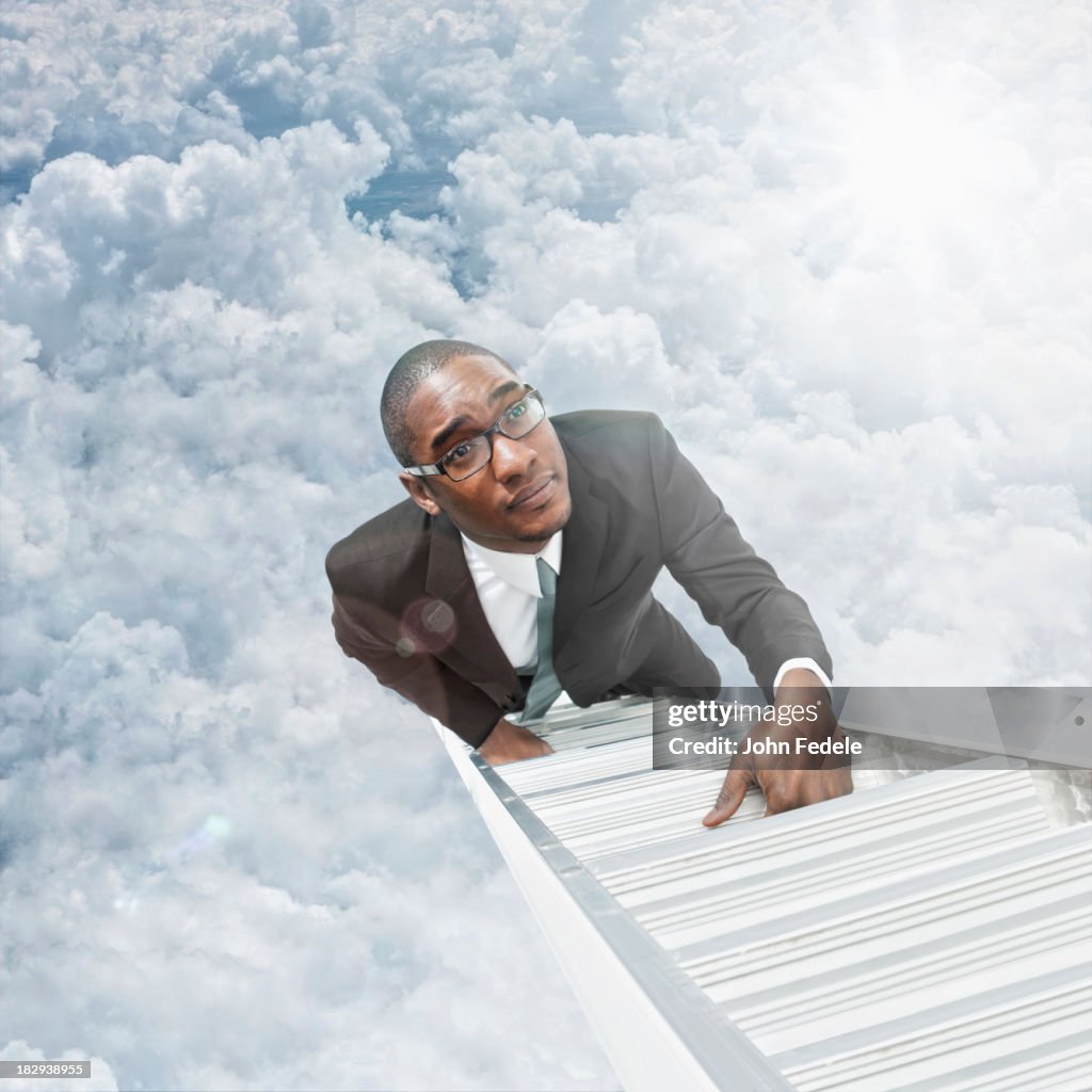 African American businessman climbing ladder