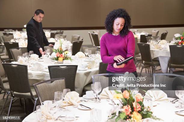 businesswoman using tablet computer in dining room - event planner stock pictures, royalty-free photos & images