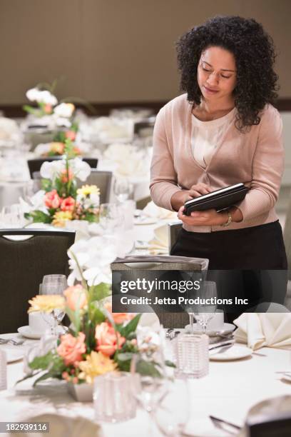 african american businesswoman working in dining room - event planning stock pictures, royalty-free photos & images