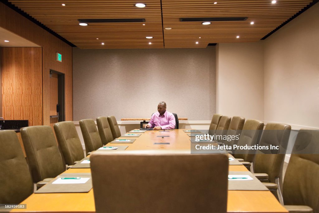 African American businessman sitting at meeting table