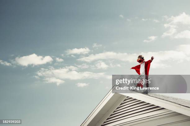 caucasian boy in cape at edge of roof - wing suit stock pictures, royalty-free photos & images