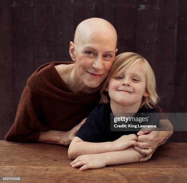 older caucasian cancer survivor with grandson - cancer portrait stock-fotos und bilder