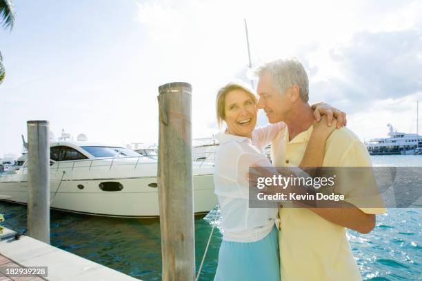 caucasian couple hugging on dock - florida marina stock pictures, royalty-free photos & images