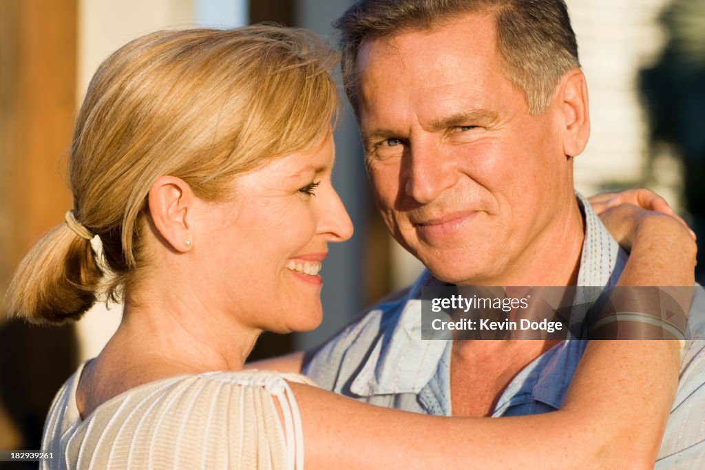 Caucasian couple hugging outdoors